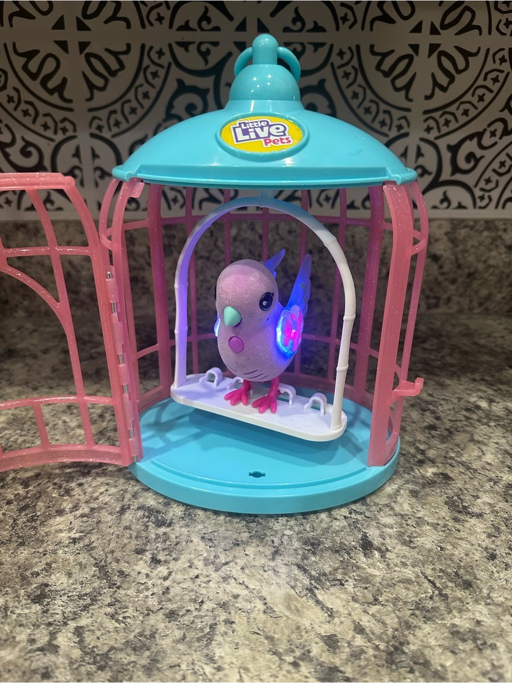 Little Live Pets Light-Up Purple Bird in Blue & Pink Cage Interactive Toy Set